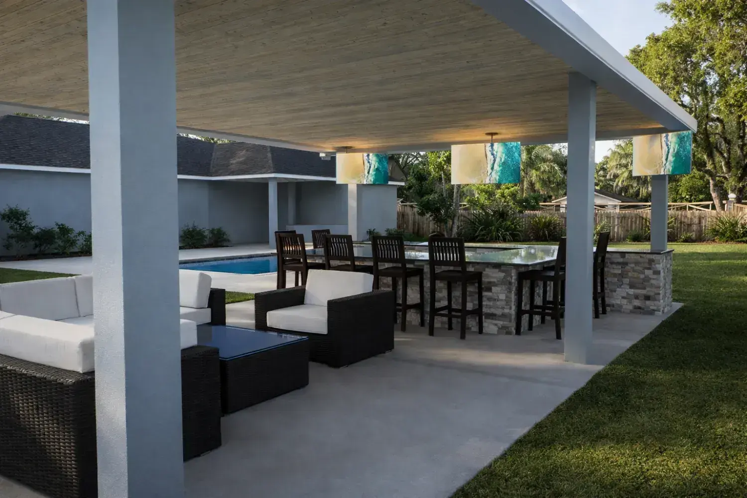 3D rendering: covered pavilion bar with counter seating and pendant lights beside the pool